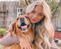 She is accompanied by a big furry dog in her home.